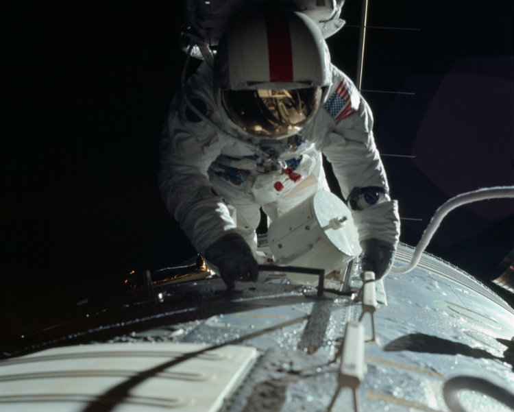 Apollo astronaut retreiving film cassettes from the Command Module