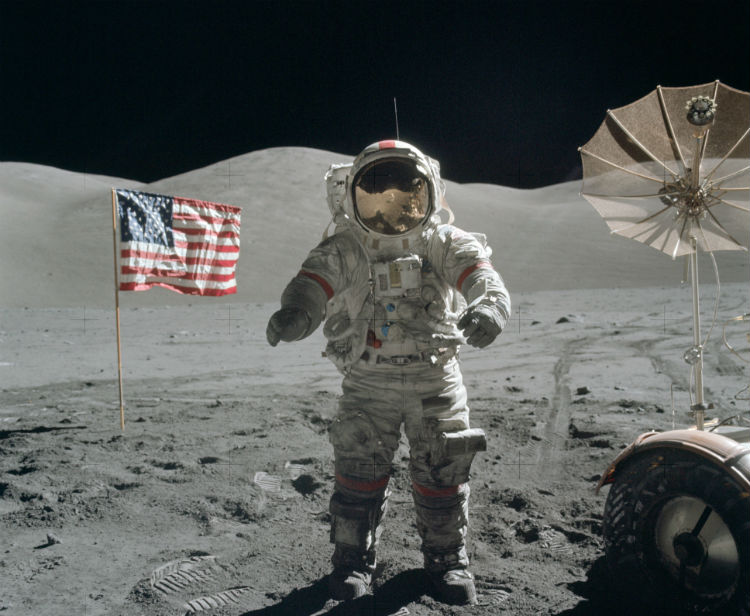 Apollo Astronaut next to the American flag on the Moon